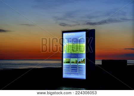 KOLOBRZEG, WEST POMERANIAN / POLAND: Tourist information board on the seaside promenade