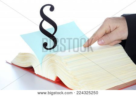 man is searching in a law book with paragraph symbol