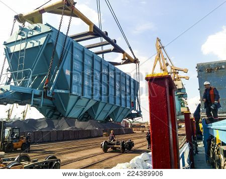 Novorossiysk, Russia - October 10, 2017: Wagon of the hopper for unloading on a cargo ship. Lifting operations in the port.