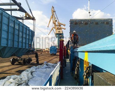 Novorossiysk, Russia - October 10, 2017: Wagon of the hopper for unloading on a cargo ship. Lifting operations in the port.