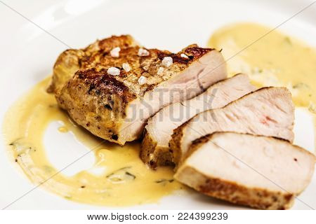 Grelled pork chop steak on white dish on white background