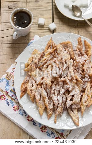 Angel wings biscuits, a traditional European sweet dish for carnival. Rustic style, selective focus.