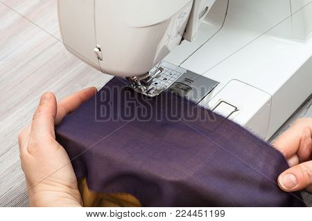 workshop on sewing a patchwork scarf - designer sews bands of fabrics for the future silk shawl with sewing machine
