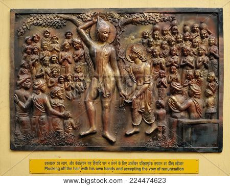 KOLKATA,INDIA - FEBRUARY 09, 2016: Plucking off the hair with his own hands and accepting the vow of renunciation, relief on the wall of Jain Temple (also called Parshwanath Temple) in Kolkata.