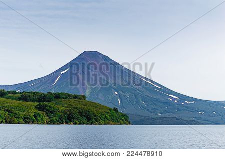 Kurile lake. Kamchatka. Russia. Wild nature Green fields and volcanoes