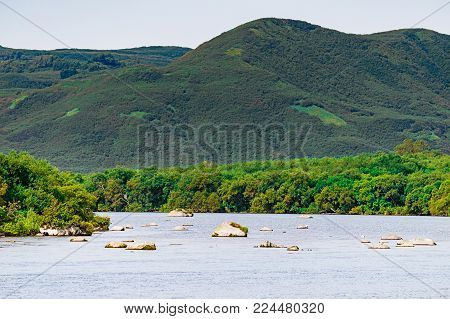 Kurile lake. Kamchatka. Russia. Wild nature Green fields and volcanoes