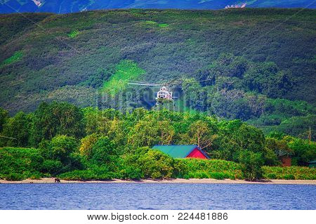 Kurile lake. Kamchatka. Russia. Wild nature Green fields and volcanoes