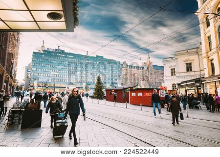 Helsinki, Finland - December 10, 2016: Women Carrying Suitcases Near Stockmann Department Store On Aleksanterinkatu Street In Winter Day.