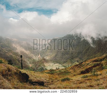 Panoramic view of the mountain valley of Santa Antao island in Cape Verde. Big clouds moving over the mountains and gethering over the lush green Xo-Xo valley.