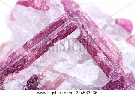 Rough white quartz studded with pink tourmaline crystals, from Brazil isolated on white background