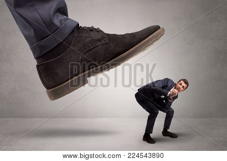Young businessman illustrated inconsiderable by being trampled