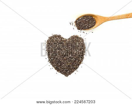 Heart shaped chia seeds and wooden spoon isolated on white background