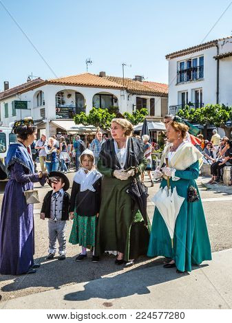 Saint-Marie-de-la-Mer, Provence, France - May 25, 2015. Women and children in fabulously beautiful medieval clothes. World Festival of Gypsies. The concept of ethnographic tourism