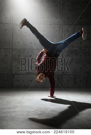 Young stylish male breakdancer posing in studio