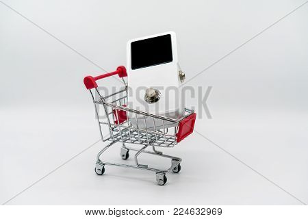 White guitar pedal and red shopping cart isolated on white background
