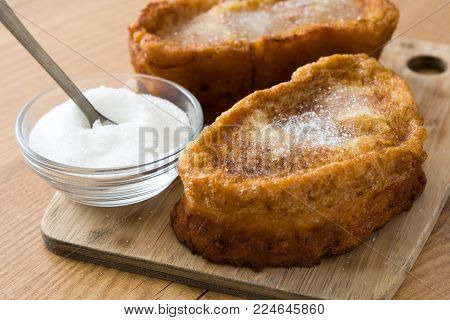 Traditional homemade Spanish torrijas on wooden background. Easter dessert.