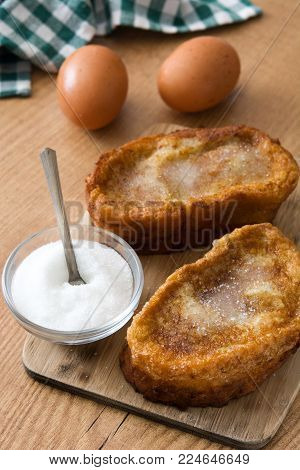 Traditional homemade Spanish torrijas on wooden background. Easter dessert.