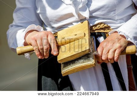 Closeup on cotton spinner woman transforming raw wool during exhibition