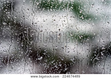Rain Drops On Glass With Dark Clouds. Weather Forecast.