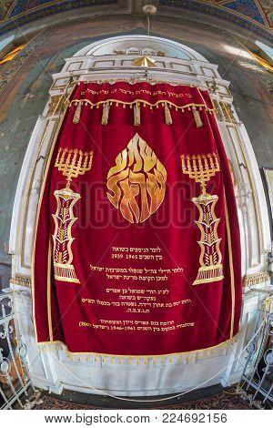 ORADEA, ROMANIA - JANUARY 27, 2018: Altar inside of one small Orthodox Synagogue with one drapery inscribed in the Hebrew language.