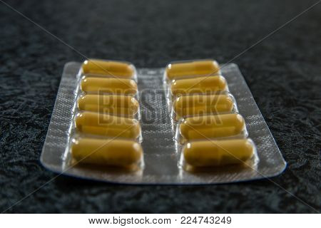 Pile of pills in blister pack with capsules. Close up shot.