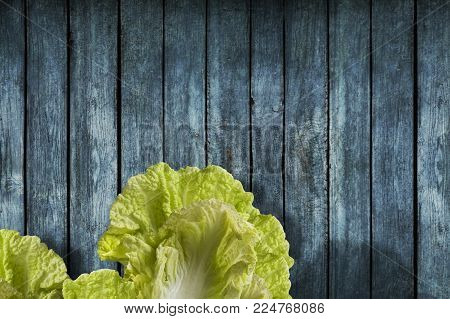 Napa or Nappa cabbage on wooden background. Chinese cabbage, Brassica pekinensis
