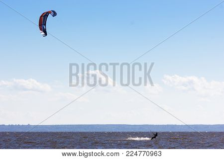 Extreme water sport - kiteboarding at the gulf of finland at summer sunny day