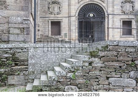 SANTIAGO DE COMPOSTELA,SPAIN-NOVEMBER 23,2017:Ancient building, stone stairs and iron gate entrance church San Domingos de Bonaval.Santiago de Compostela,Spain.