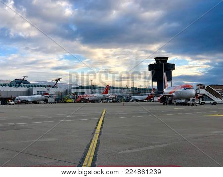 LONDON - FEBRUARY 1, 2017: Parked commercial aircraft at Geneva Cointrin International Airport in Geneva, Switzerland.