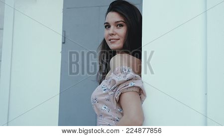 Happy beautiful woman walking in the city, steadicam shot 4k