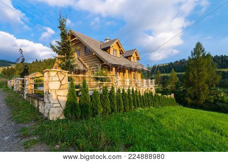 Traditional wooden mountain house built from wood logs on summer sunny day, Pieniny Mountains, Jaworki, Poland