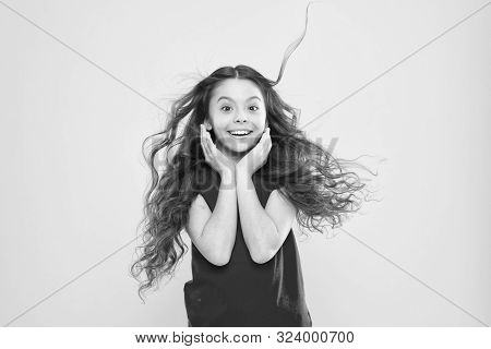 Things You Doing To Damage Your Hair. Girl Adorable Kid Long Wavy Hair Yellow Background. Wind Can A