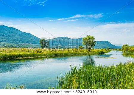 Beautiful Nature Landscape, Gacka River Among Grass Banks, Lika Region Of Croatia