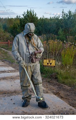 Chemist-dosimetrist Measures The Radiation Of The Concrete Pavement Of The Road On The Background Of