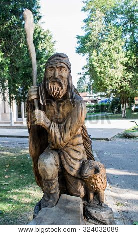Romania, Bran, September, 20, 2019- A Beautiful Wood Carving Representing A Dac And A Sheep