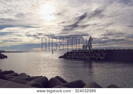 Sunset View At Jeju Island Near Iho Tewoo Beach With White Horse Shaped Lighthouse View