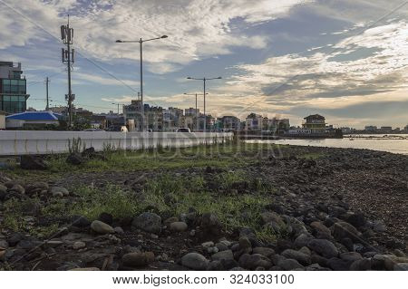 View On Cityscape Of Jeju From Lavarock Shore With Beautiful Cloudscape At Sunset