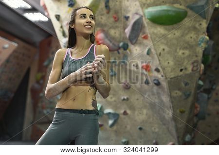 Athletic Smiling Woman With Muscular Naked Torso Is Training In Climbing Gym Indoor.