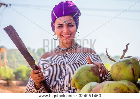 Happy African American Woman Opening Cutting Coconut With Machete.indian Girl Open Coco Nut Water In