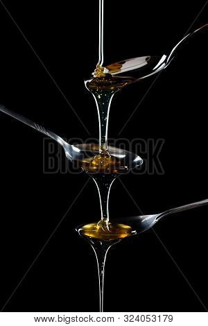 Golden Sweet Honey Dripping From Spoon