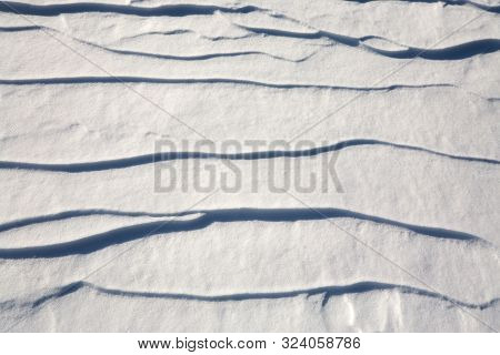 Elongated Ridges Of Snow Across The Wind. Landform Background