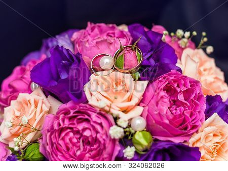 Rings Of The Bride And Groom On The Wedding Bouquet Of Roses, Eustome And Peony Roses, Close-up, Top