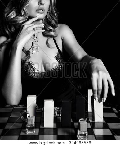 Black And White. Young Curvy Blonde Woman In Lace Nightie With Deep Neckline Playing Chess With Perf