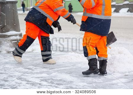 Communal Services Workers Sweep Snow From Road In Winter, Cleaning City Streets And Roads After Snow