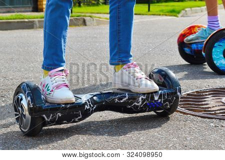 Dear Baby Present. Riding A Scooter On The Road.