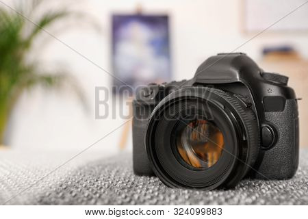 Professional Digital Camera Against Blurred Background. Space For Text