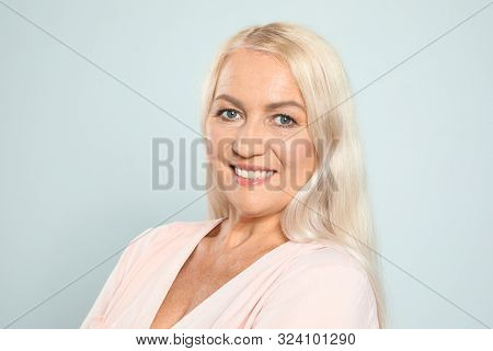 Portrait Of Mature Woman With Beautiful Face On Grey Background