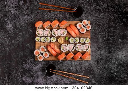 Sushi Set Of Nigiri And Maki Rolls Served On Wooden Board. Japanese Food. Top View
