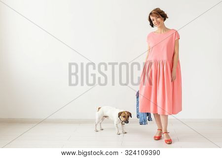 Pets Owner Concept - Young Woman In Pink Dress With Jack Russell Terrier Dog Over The White Backgrou