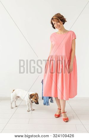 Pet And People Concept - Young Woman In Pink Dress With Jack Russell Over The White Background